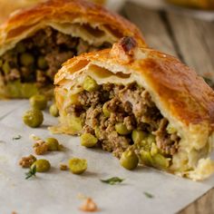 a close up of a pastry with meat and peas