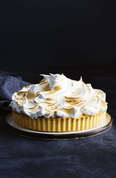 a cake with white frosting sitting on top of a plate