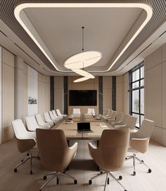 a conference room with white chairs and a large table in the center, along with a flat screen tv on the wall