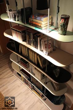 there is a shelf with books on it and a lamp next to the bookcase