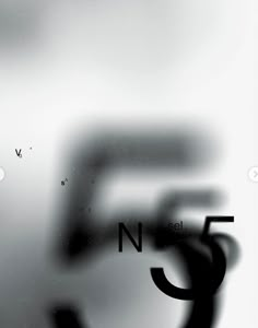 blurry photograph of letters and numbers in black and white with the letter n5