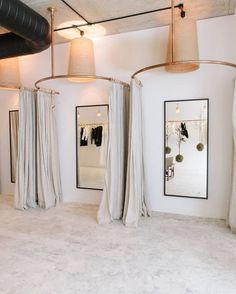 three lamps hanging from the ceiling in a room with white walls and carpeted floors