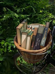 a basket filled with books sitting on top of a bike