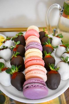 there is a plate with different types of desserts on it, including strawberries and macaroons