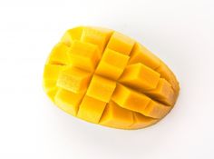 a piece of mango sitting on top of a white table