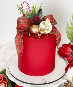 a red cake decorated with christmas decorations and candy canes