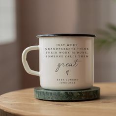 a white coffee mug sitting on top of a wooden table