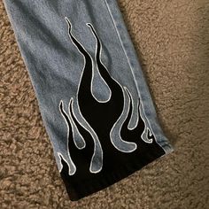 a pair of jeans with flames painted on them