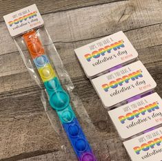 four different colored toothbrushes sitting on top of a wooden table next to each other