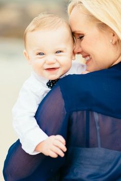 a woman holding a baby in her arms