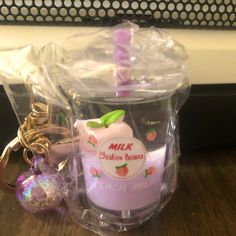 a pink candle and keychain sitting on a table