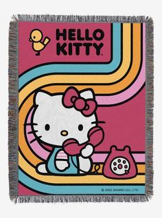 a hello kitty throw blanket with an image of a phone and a cat on it