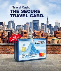 an advertisement for travel cash on the side of a brick wall in front of a cityscape