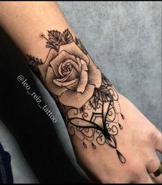 a black and white rose tattoo on the left foot, with an arrow in the middle