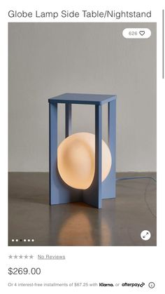 a blue table lamp with a white light on it's side and the text globe lamp side table / night stand