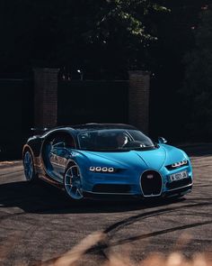 a blue bugatti is driving down the road