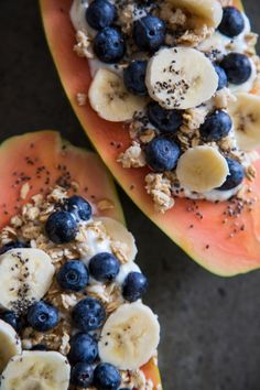 two slices of watermelon with blueberries, bananas and granola on top