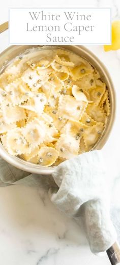 white wine lemon caper sauce in a bowl on a marble counter top with the title above it