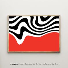 a red and black abstract painting hanging on a wall