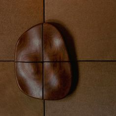 a close up of a wooden object on a tile floor