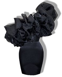 a black vase filled with flowers on top of a table