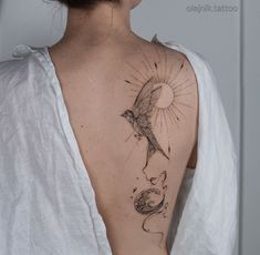 a woman with a bird tattoo on her back