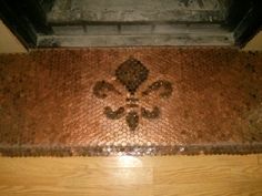 a tile floor with a fleur de lis design on the top and bottom