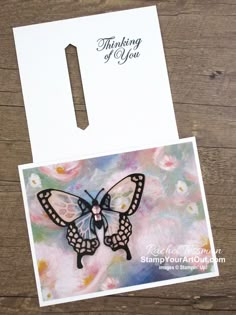 a card with a butterfly on it and the words thinking of you written in black ink