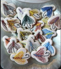 decorated cookies in the shape of hearts on a plate with scissors and string attached to them