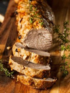 sliced meat on a cutting board with herbs