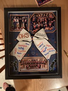 a group of people are hanging on a wall with pictures and ribbons attached to it