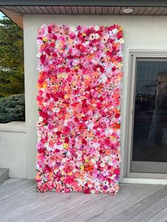 a large flower covered wall on the side of a building