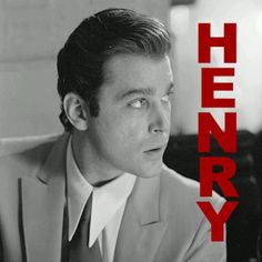 a black and white photo of a man in a suit with the words henry on it