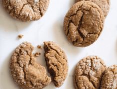 several cookies are arranged on a white surface