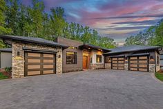 a large house with two garages in the front and one on the other side