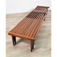 a wooden bench sitting on top of a hard wood floor