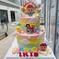 a three tiered cake with cartoon characters on it