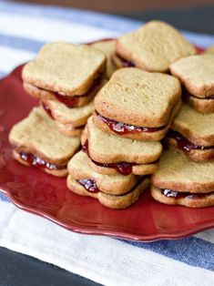 a red plate topped with cookies covered in jelly