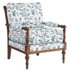 an upholstered chair with blue and white floral fabric on it's arms