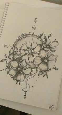 a drawing of flowers and a clock on paper