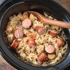 a crock pot filled with sausage and rice