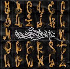 some type of graffiti written in gold and black with the letters on it's sides