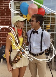 a man and woman standing next to each other in front of a building with balloons