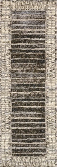 an area rug with stripes and lines in grey, beige and black colors on the ground