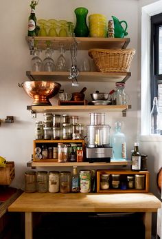 the shelves are filled with various kitchen items