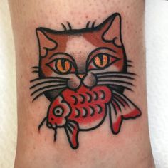 a cat with a fish tattoo on its leg