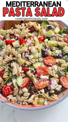 pasta salad with tomatoes, cucumber and other vegetables in a bowl