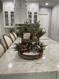 two tiered trays filled with christmas decorations on top of a kitchen countertop