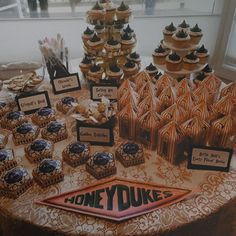 a table topped with lots of cupcakes and cookies