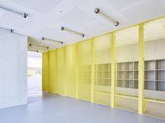 an empty room with yellow partitions and white walls